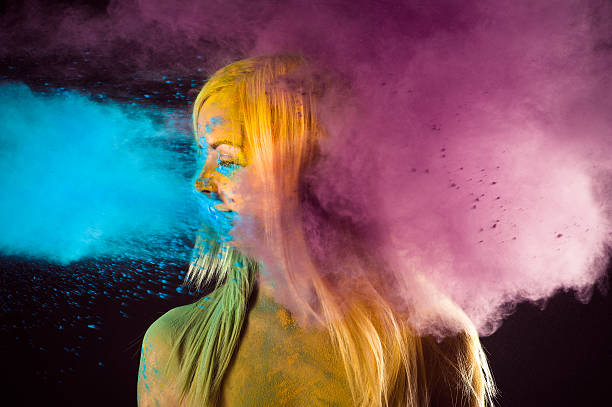 woman in bright colors Holi on black background