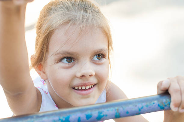 istock Five-year girl climbs the ladder on playground 480425978
