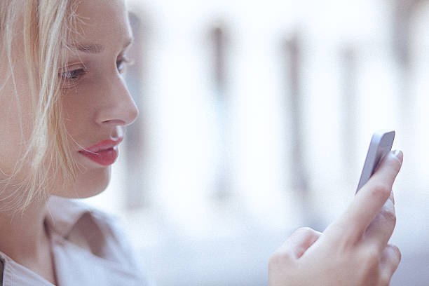 istock Young woman using a mobile phone in the urban environment 480426316