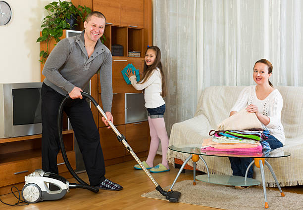istock Mother, father and girl doing general cleaning 480426926
