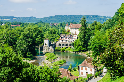A view of the Gave d'Oloron and Pont de la Legende in the medieval village of Sauveterre-de-Bearn, facing the Pyrennes in south-western France. It is a commune in the Pyrenees-Atlantiques department.