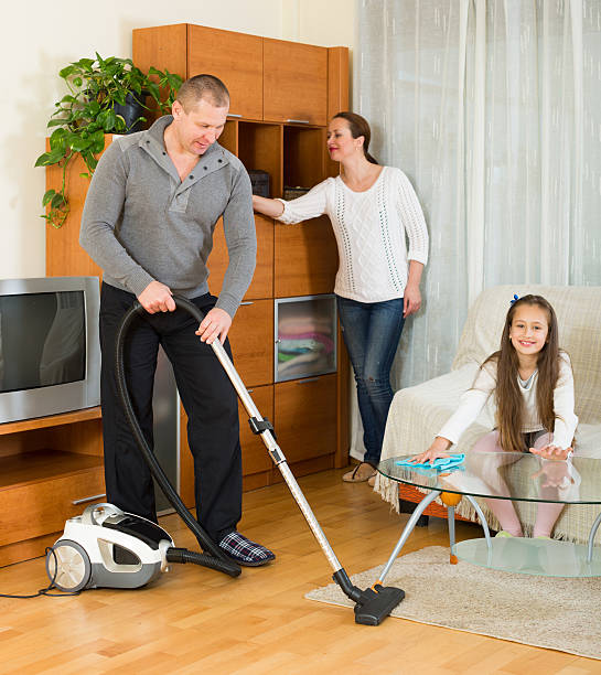 istock Mother, father and girl doing general cleaning 480437930