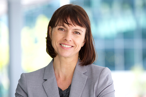 preppy fresh 60s middle aged business woman in stylish look on bright studio background with copy space.