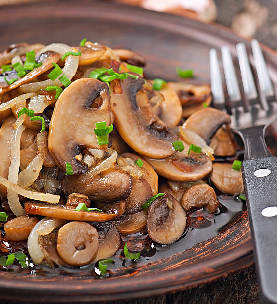istock Fried mushrooms and onions on a ceramic plate 480445471