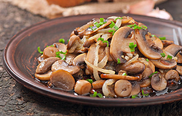 istock Fried mushrooms and onions on a ceramic plate 480445511