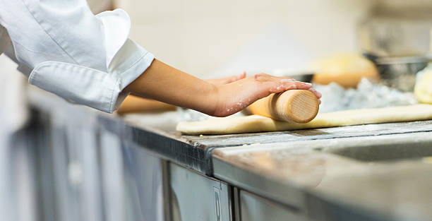 Student rolling dough stock photo