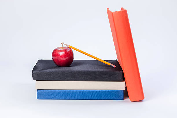 istock Pencil leans on apple and books. 480446459