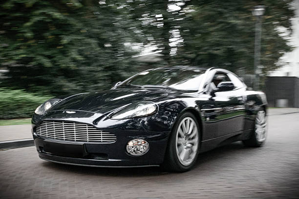 Zwolle, The Netherlands - September 6, 2014: Blue Aston Martin Vanquish sports car driving fast on the street in the city of Zwolle, The Netherlands.