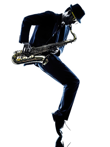 one caucasian man  saxophonist playing saxophone player in studio silhouette isolated on white background