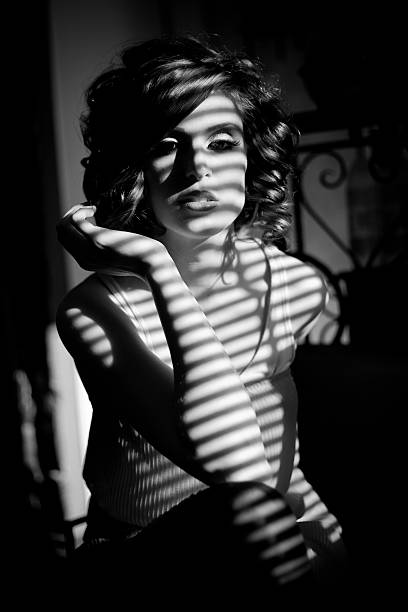 istock Woman in shadow of binds roller posing 480452675