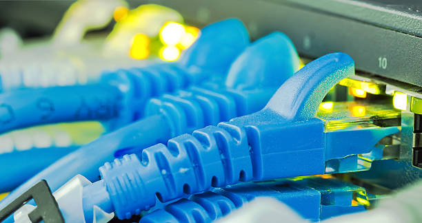 Ethernet cables Ethernet cables with blue color connector plug in to equipment broadband isp stock pictures, royalty-free photos & images