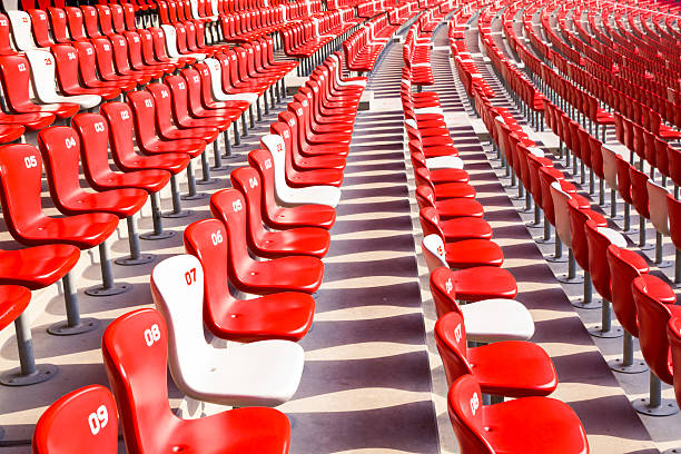 istock Red chairs bleachers in large stadium 480454665