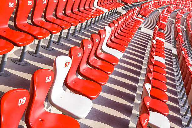 istock Red chairs bleachers in large stadium 480454669