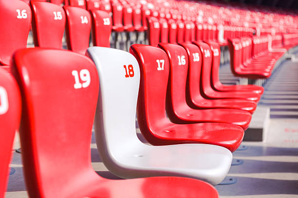 istock Red chairs bleachers in large stadium 480454753