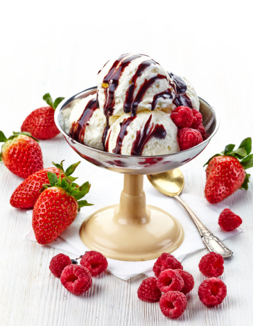 ice cream portion with chocolate sauce and fresh berries