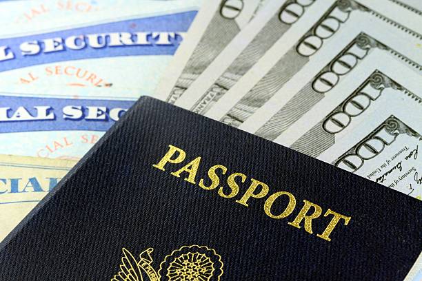 istock Travel Documents - USA Passport with American Currency 480456755