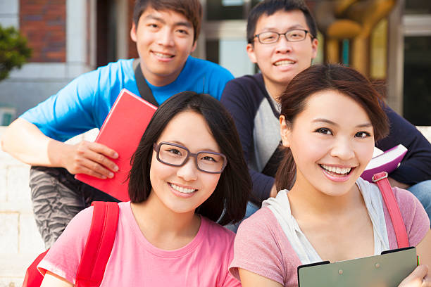 istock happy university students sitting on stair 480457213