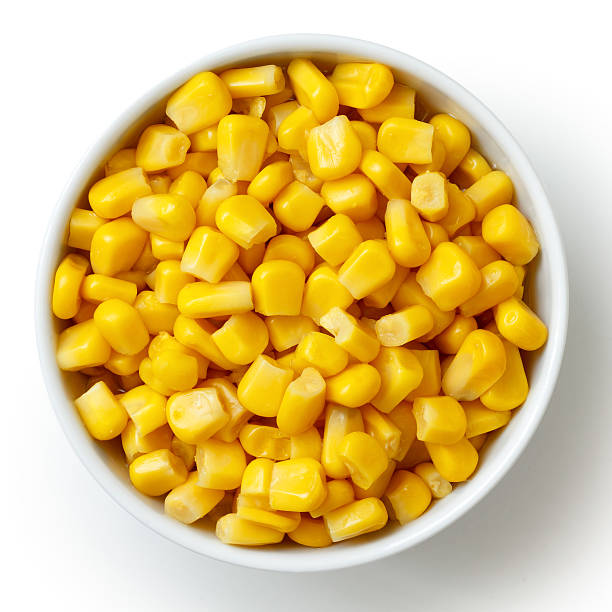 Bowl of tinned sweetcorn isolated from above on white. Bowl of tinned sweetcorn isolated from above on white. sweetcorn stock pictures, royalty-free photos & images