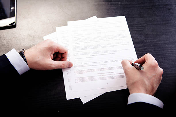 istock Image of human hand with pen over documents at workplace 480458378