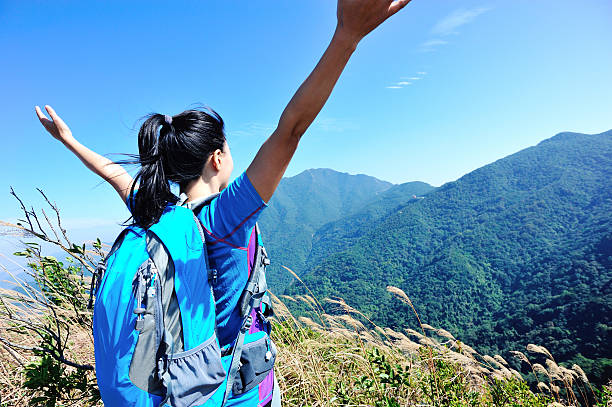 istock cheering hiking woman at mountain peak 480458547