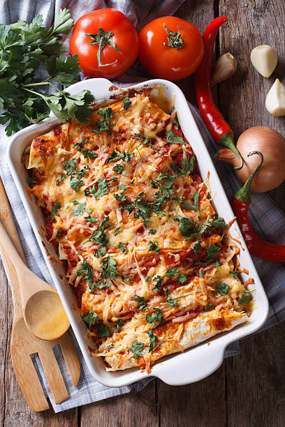 istock Mexican enchilada in a baking dish vertical top view close-up 480462340
