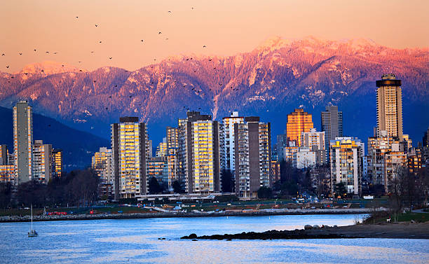 Vancouver Skyline Harbor English Bay Birds Snow Mountains Sunset Vancouver Skyline Harbor High Rises Sailboat Birds English Bay From Jericho Beach Snow Mountains Sunset British Columbia Pacific Northwest beach english bay vancouver skyline stock pictures, royalty-free photos & images