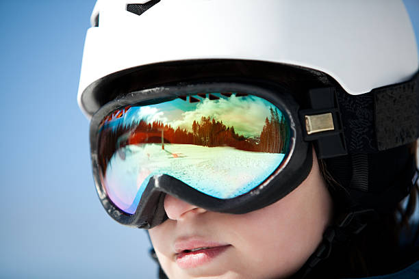 istock female snowboarder against sun and sky 480464543