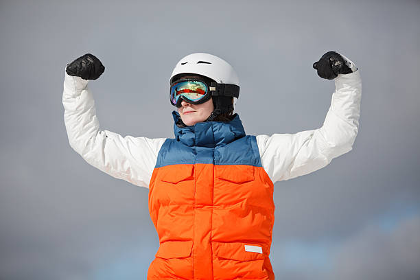 istock female snowboarder against sun and sky 480464569