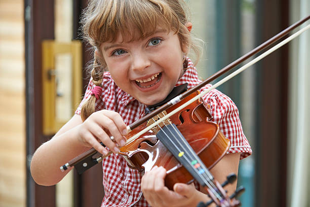 istock Young Girl At School Learning To Play Violin 480465146