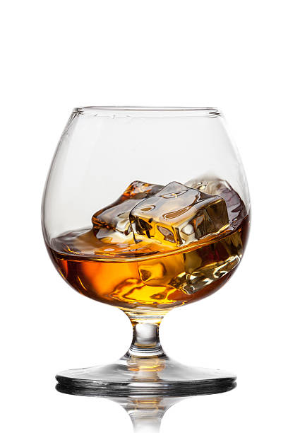 istock Splash of whiskey with ice in glass isolated on white 480468057