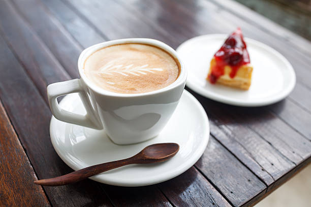 istock Cup of latte coffee with cake 480473975