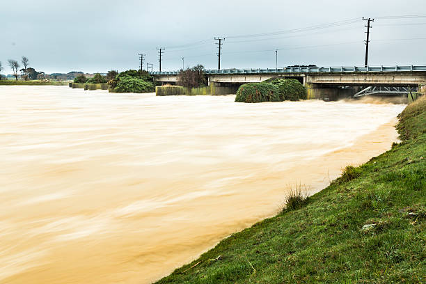 Open Flood Gates Moutoa flood gates fully open releasing flood waters out of the Manawatu river manawatu stock pictures, royalty-free photos & images