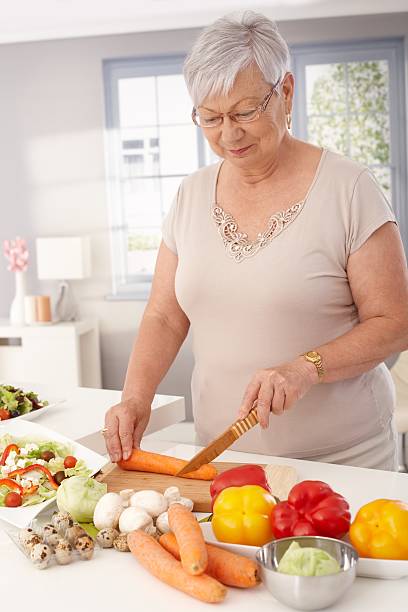 istock Old lady cooking healthy 480477941