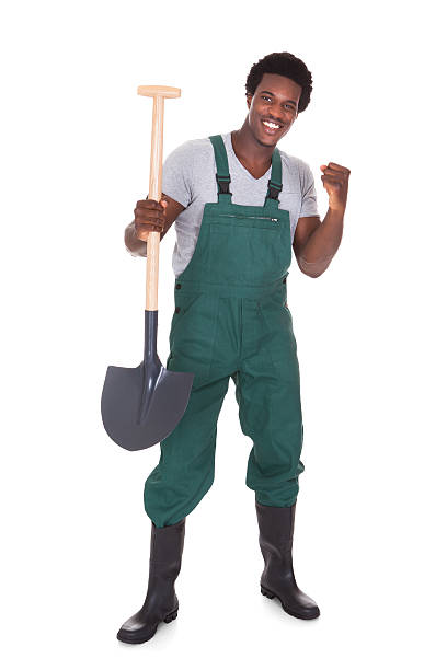 Happy Male Gardener Holding Shovel Over White Background