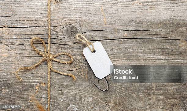 String Tied In A Bow And Address Label Attached Stock Photo - Download Image Now - Backgrounds, Business, Cardboard