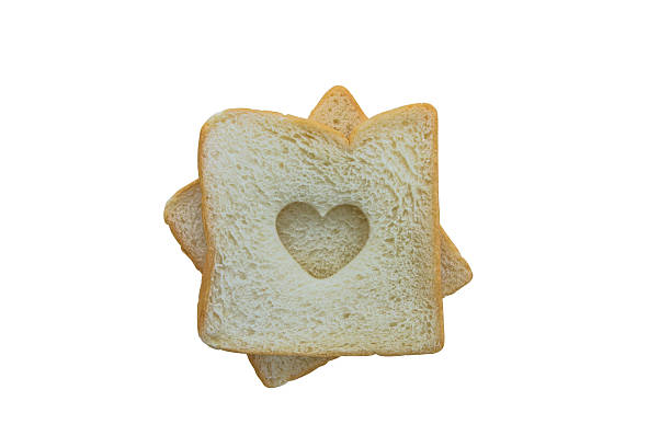 istock Heart shaped hole in a slice of bread isolated 480480958