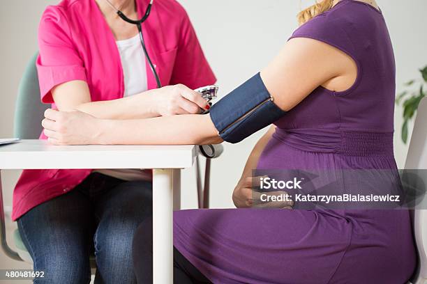 Doctor Measuring Pressure Stock Photo - Download Image Now - Pregnant, Blood Pressure Gauge, Hypertensive