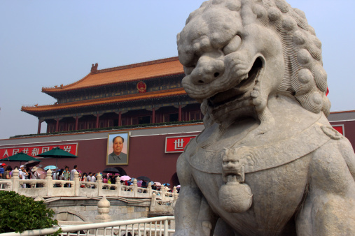 Beijing, China - July 29, 2013: A foo dog guards the entrance to the Forbidden City in Beijing.