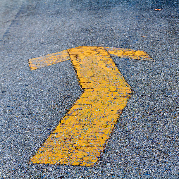 istock Yellow painted arrow Indication of the road surface 480492377