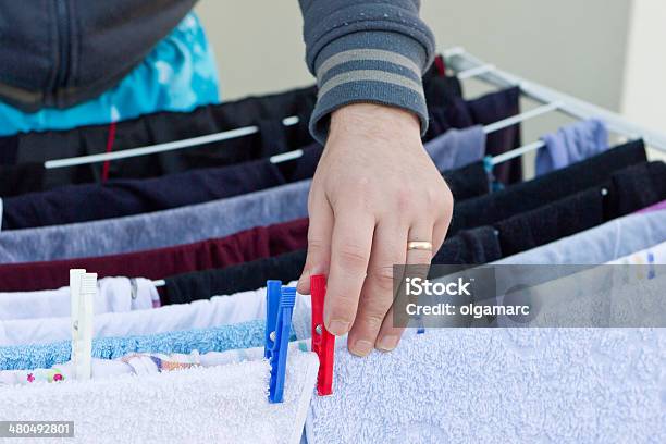 Young Man Drying Clothes After Laundry Stock Photo - Download Image Now - Adult, Clean, Cleaning