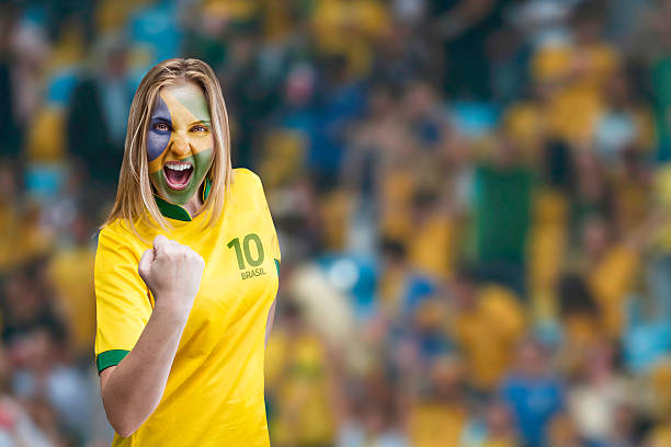 Brazilian woman celebrates on the arena with her face painted Brazilian woman celebrates on the arena with her face painted maracanã stadium stock pictures, royalty-free photos & images