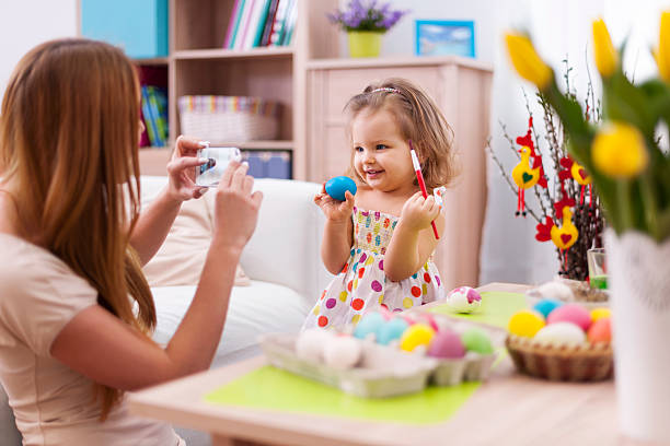 istock Proud mother take a picture her daughter with easter egg 480494177