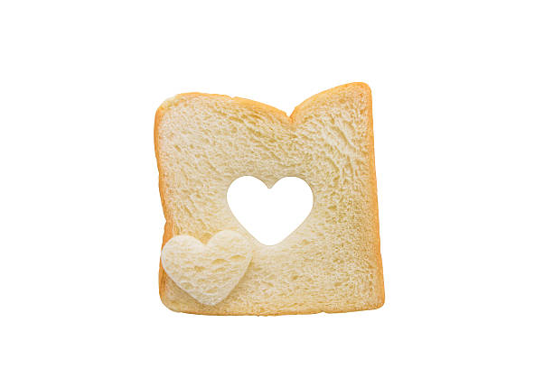 istock Heart shaped hole in a slice of bread isolated 480496258
