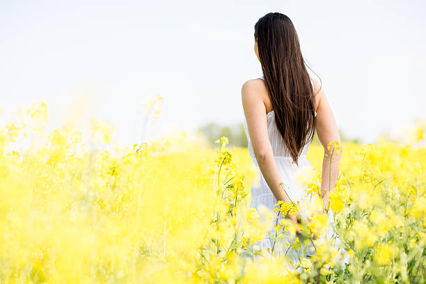 istock Young woman in the spring field 480496924