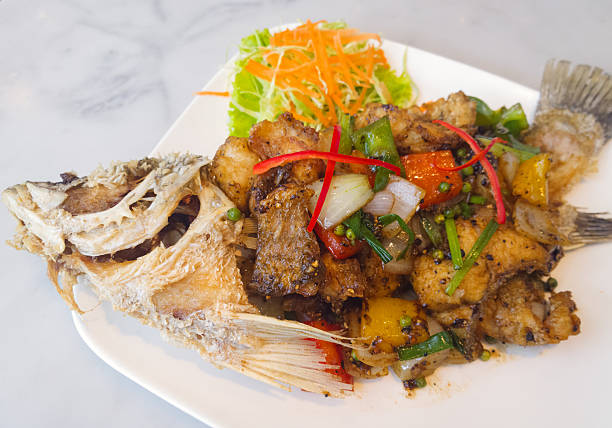 istock spicy sea bass fried with black pepper on white plate 480497819