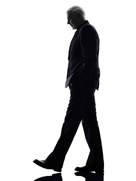 istock senior business man walking silhouette 480497989