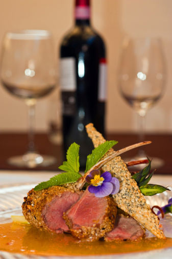 Lamb chops with red wine bottle