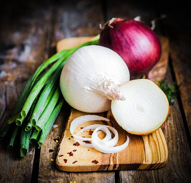 istock colorful onions on rustic wooden background 480498831