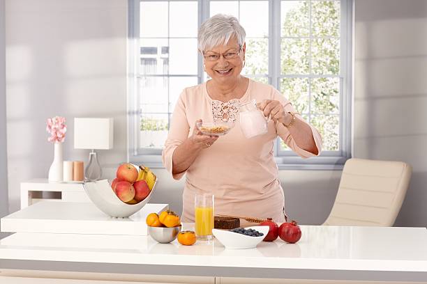 istock Happy old woman eating healthy 480499005