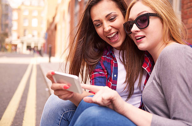 istock Two best friends sitting on the pavement 480499218